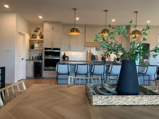 Benjamin Moore Stone Hearth on kitchen cabinets in an open plan kitchen diner. The cabinets look true to tone but the island looks blue.