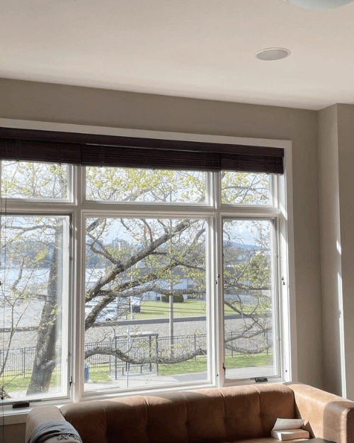 Benjamin Moore Stone Hearth looks like a gray stone color around a large living room window