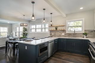 Benjamin Moore Gray Owl on kitchen walls with dark charcoal navy cabinets.