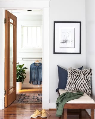 Benjamin Moore owl gray on walls where it looks silvery gray with warm wood floors and white trim.