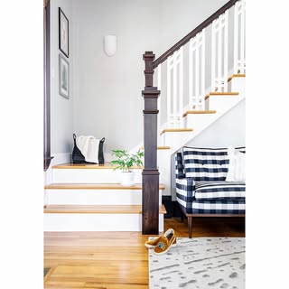 Benjamin Moore Gray Owl in a living room and stairwell walls with white trim and warm wood floors.