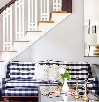 Benjamin Moore Gray Owl in a living room and stairwell walls with white trim and warm wood floors.