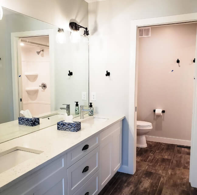 Benjamin Moore Gray Owl in a bathroom with a more green undertone reflected in the mirror