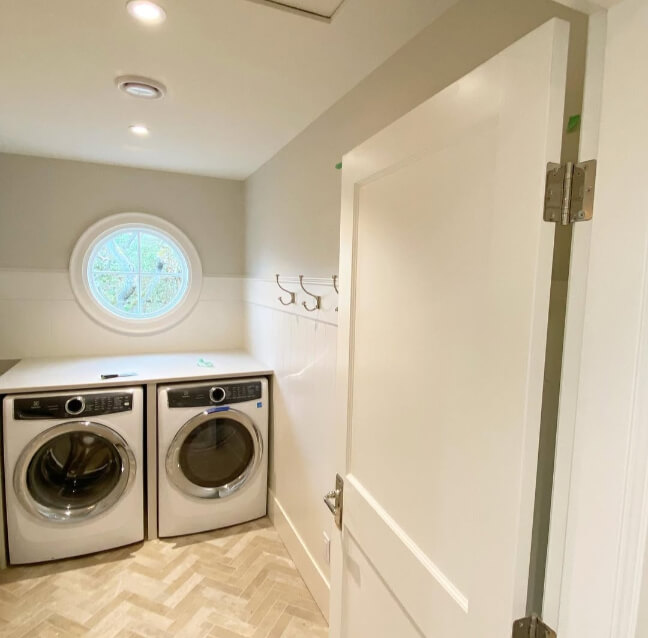 Benjamin Moore Gray Owl in a laundry room on the top portion of the walls and White Dove on the lower 2/3s.
