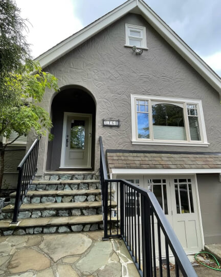 Benjamin moore Iron Gate on a stucco home and Pashmina on the front door and garage door.