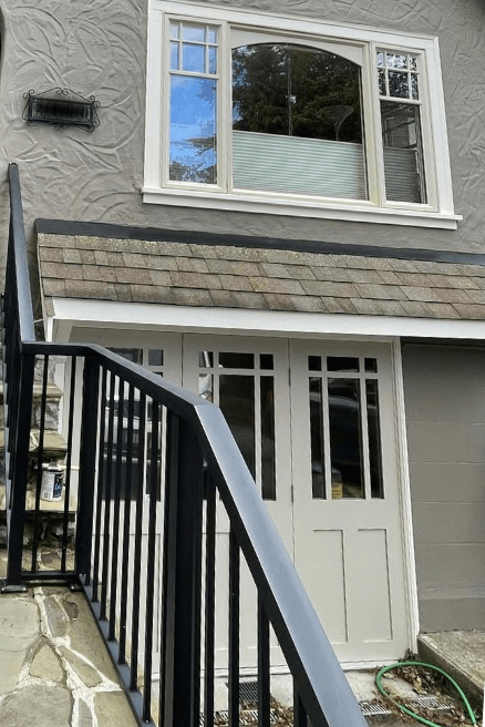 Benjamin Moore Pashmina on a garage door with Iron Gate gray stucco