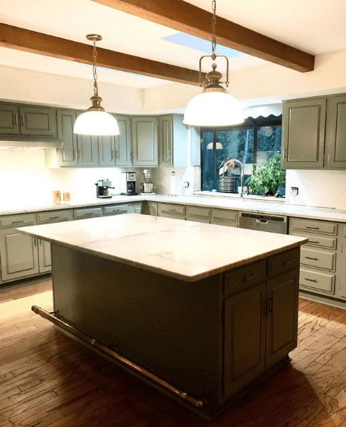 Sherwin Williams Evergreen Fog on perimeter kitchen cabinets in a large kitchen with a dark wood island