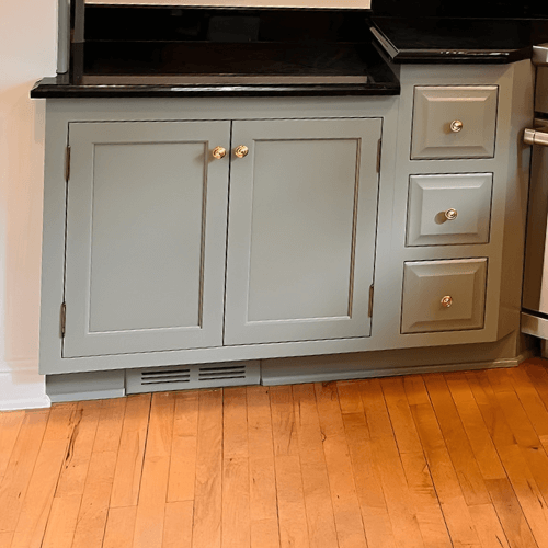 Evergreen Fog kitchen cabinets with gold hardware