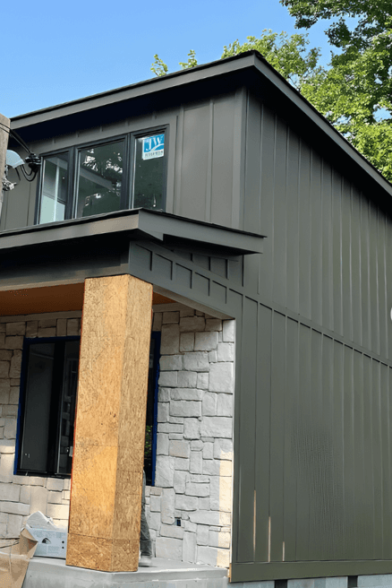 Sherwin Williams Urbane Bronze down the long side of a two storey home.