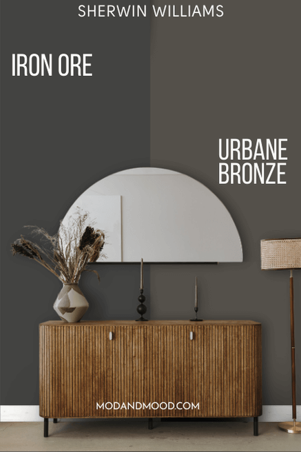 Sherwin Williams Urbane Bronze on half of a wall and Iron Ore on the other half behind a half moon mirror and a hall table.