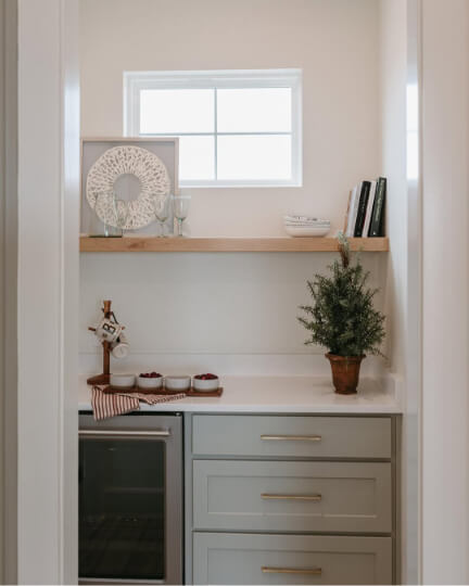 Sherwin Williams Evergreen Fog at 50% on kitchen cabinets in a butler's pantry.
