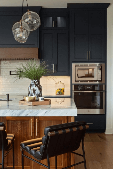 Benjamin Moore Blue Note on kitchen cabinets in a modern kitchen with a honey oak wood island, warm wood floors, and a little brown dog.