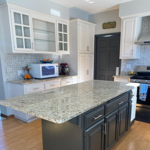 White heron on perimeter cabinets and Urbane Bronze on an island and door in a kitchen remodel