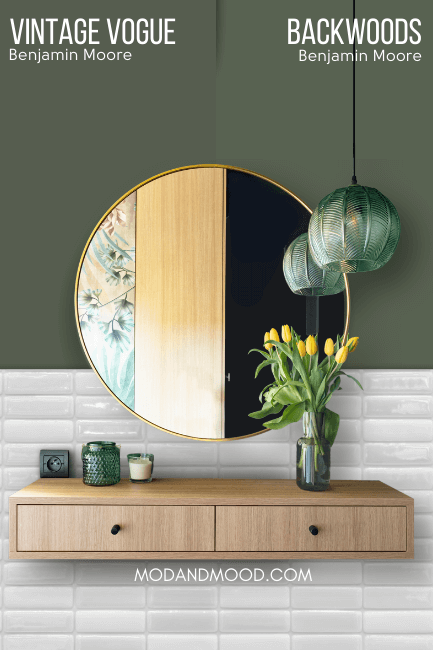 Benjamin Moore Backwoods on half of a wall compared to the other half of the wall in Benjamin Moore Vintage Vogue behind a round mirror and wood vanity.