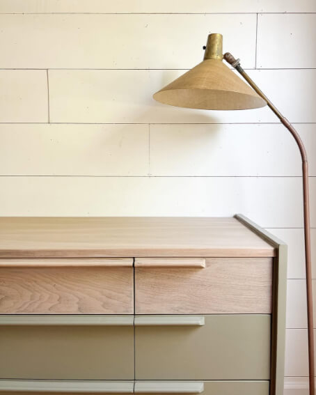 Benjamin Moore Country Life on a mid century modern style dresser with a small lamp above.