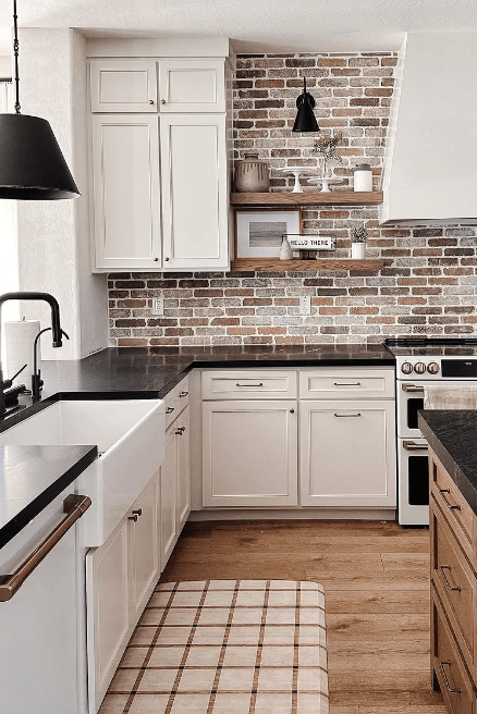 Sherwin Williams Aesthetic White on kitchen cabinets with a red brick backsplash and black countertops