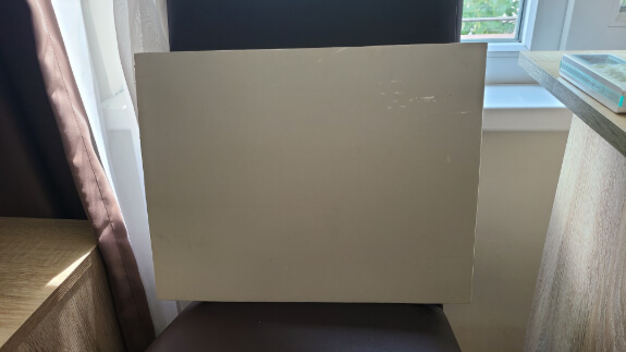 Sherwin Williams High Sierra painted on a board set up on a chair.
