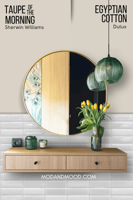 Sherwin Williams Taupe of the Morning on half of a wall and Dulux Egyptian Cotton on the other half behind a round mirror and a floating wood vanity.