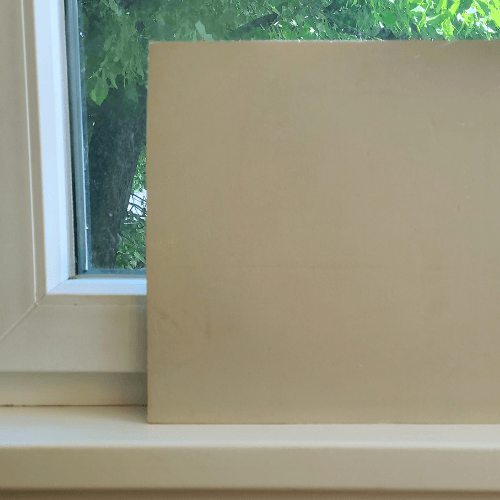 Sherwin Williams High Sierra on a foam board in a window.