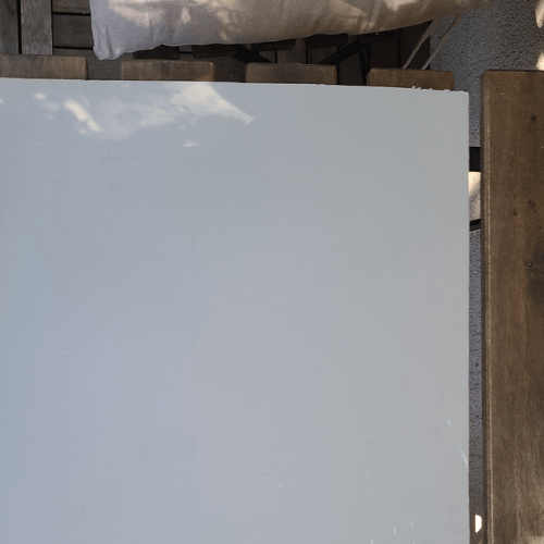 Sherwin Williams High Sierra painted on a board outside.