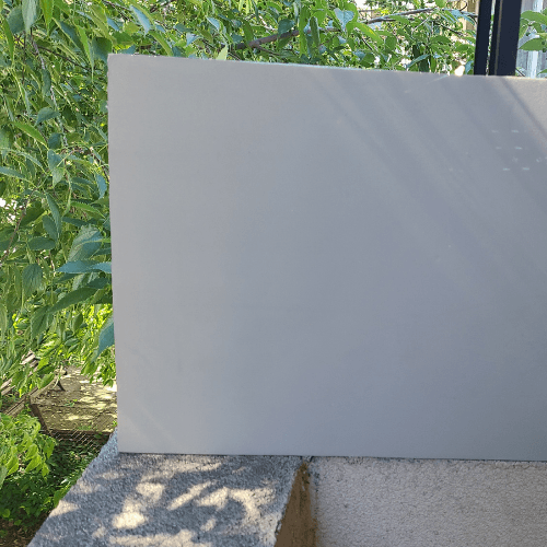 Sherwin Williams High Sierra painted on a board outside.