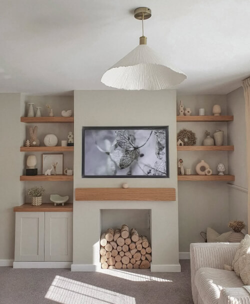 Dulux Egyptian Cotton on a living room wall with a fireplace of logs and built in cabinets on the left side.