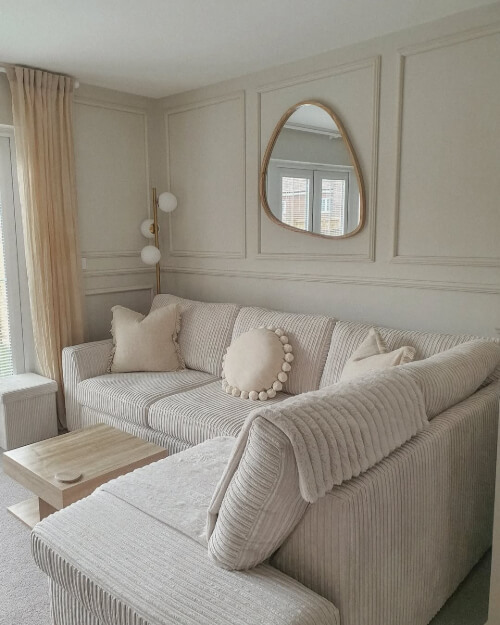 Dulux Egyptian Cotton on woodwoork in a living room behind a plush beige sofa