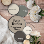Benjamin Moore Baja Dunes color palette features coordinating colors Silhouette, retreat, Maritime White, and White Flour over a wood backgroud with a blanket, peonies, and candles.