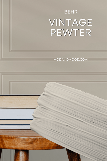 Behr swatch of vintage Pewter over the color on a wall.