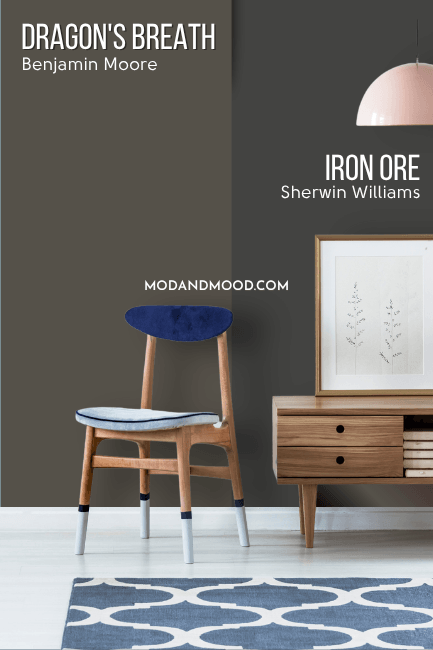 Benjamin Moore Dragon's Breath on half of a wall and Iron Ore on the other half behind a wood hall table and wood chair with blue seat cushion.