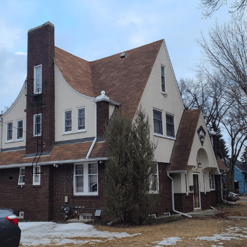 Benjamin Moore Maritime White on a Victorian stucco and brick exterior