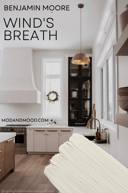 Benjamin Moore Wind's Breath swatched over a photo of the color in a large beautiful kitchen on lower cabinets.