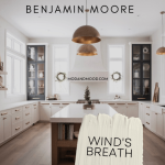 Benjamin Moore winds breath on lower cabinets in a white kitchen with a wood island.