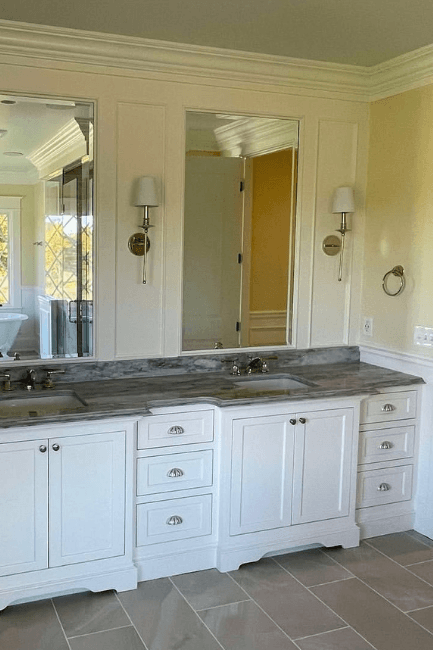 Benjamin Moore alabaster on cabinets and wainscoting in a yellow bathroom