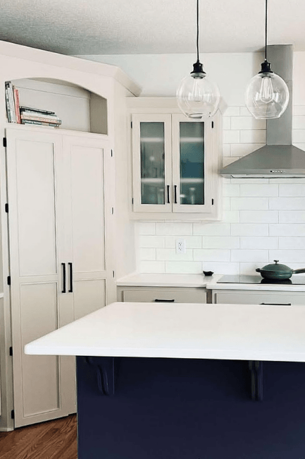 Benjamin Moore edgecomb Gray on cabinets with a charcoal blue island