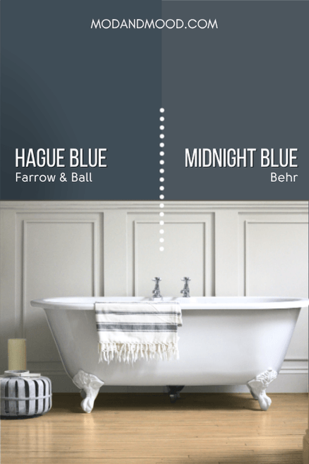 Farrow and Ball Hague Blue and Behr Midnight Blue each on half of a wall behind soft gray wainscoting and a bathtub.