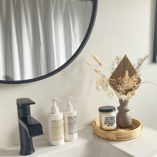 Sherwin Williams Spare White in a bathroom above a vanity.