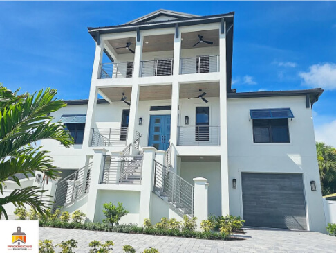 Sherwin Williams Spare White on a large stucco exterior with Morning at Sea trim and doors.