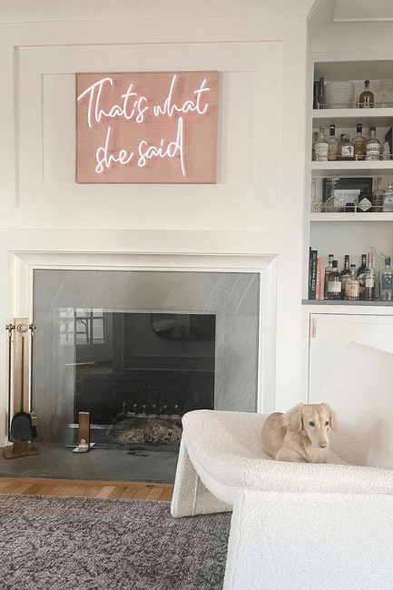 Benjamin Moore Swiss Coffee on walls in a living room with a fireplace and bookshelf and White Dove on trim where it is hard to tell what color is on which surface.