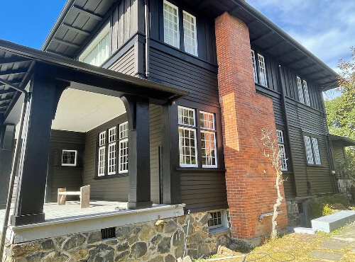 Benjamin Moore Dragon's Breath on a huge exterior with red brick chimney