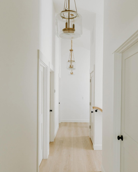 Benjamin Moore Balboa Mist on interior doors in a long hallway with swiss coffee 75% walls