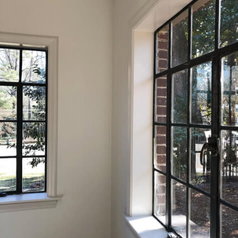 Creamy white walls in Benjamin Moore Dove Wing, with Benjamin Moore Wind's Breath on trim around windows.