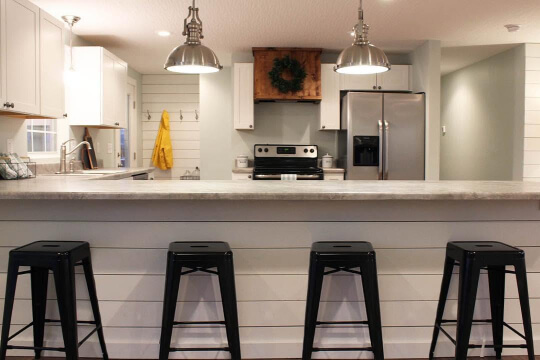 Sherwin Williams Sea Salt on a shiplap kitchen island and perimeter cabinets.