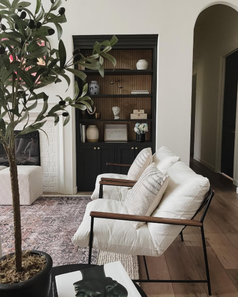 Swiss Coffee on walls in a living room with an arched hallway