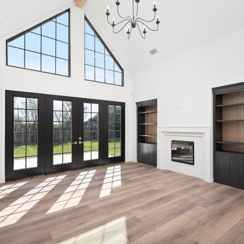 Benjamin Moore Swiss Coffee on walls in a vaulted living room with iron ore cabinets