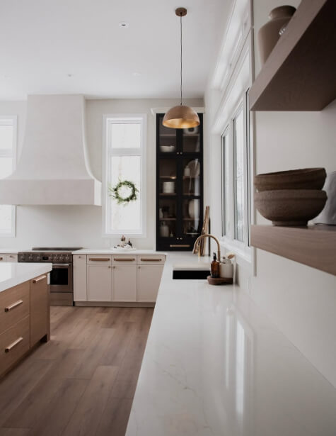 Benjamin Moore winds breath on lower cabinets in a white kitchen with a wood island and floating shelves