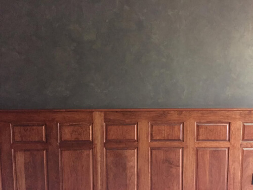 Benjamin Moore Gargoyle on spongepainted walls with cherry wood panelling.