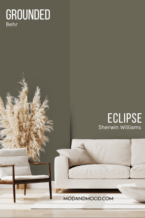 Dupe Sherwin Williams Eclipse on half of a wall and Grounded on the other half behind a beige couch and pampas grass.