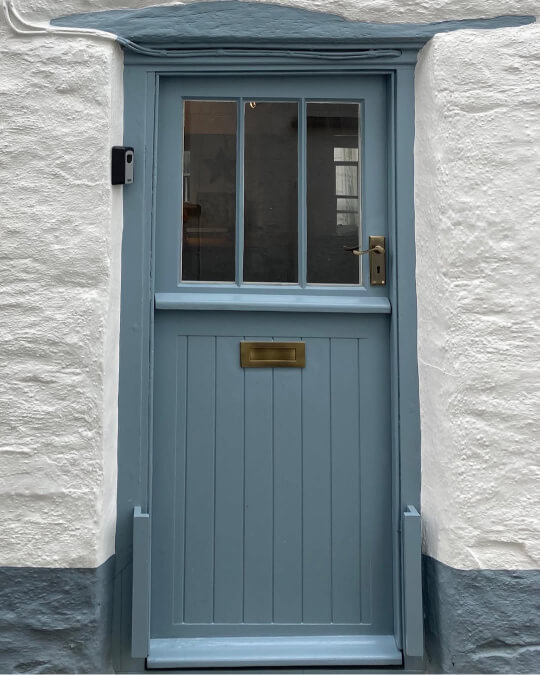 Valspar Cottage door on the door of a white stone cottage